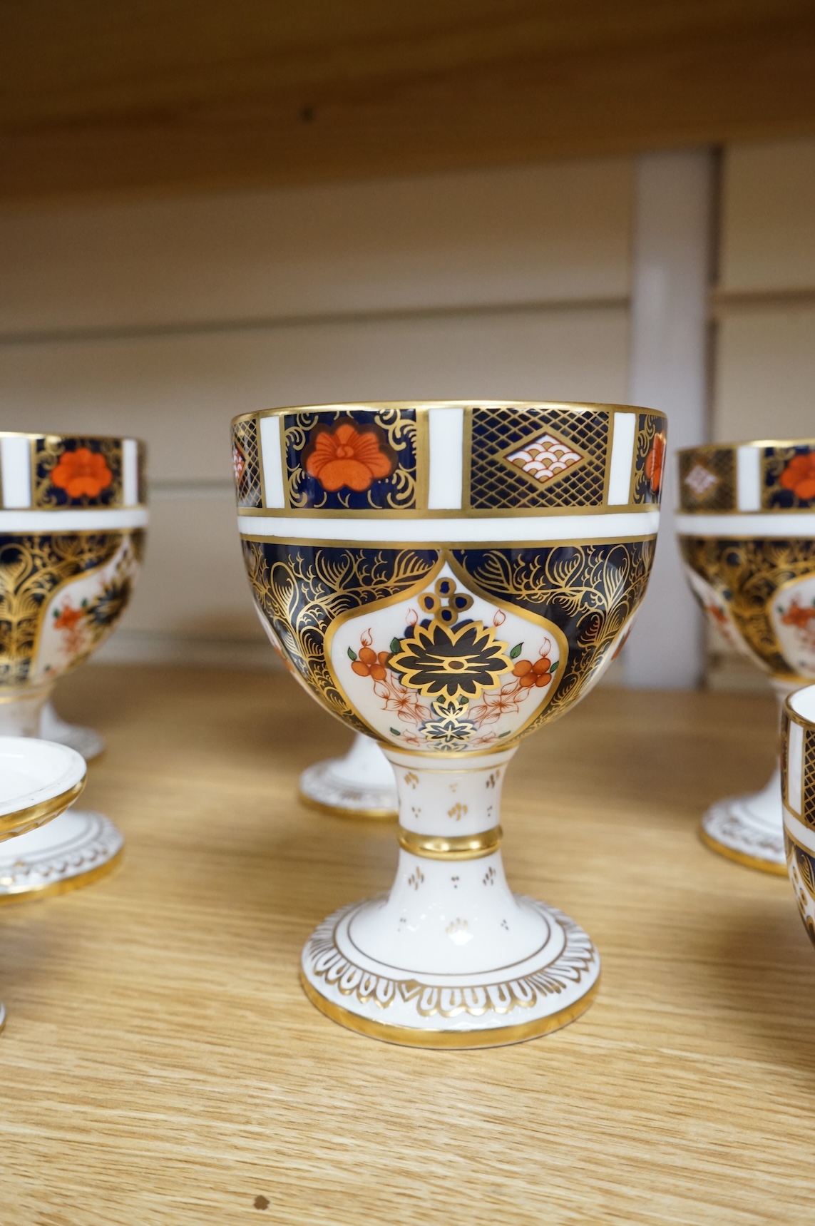 A group of six Royal Crown Derby stemmed cups (one cup and stem detached). 12.5cm high